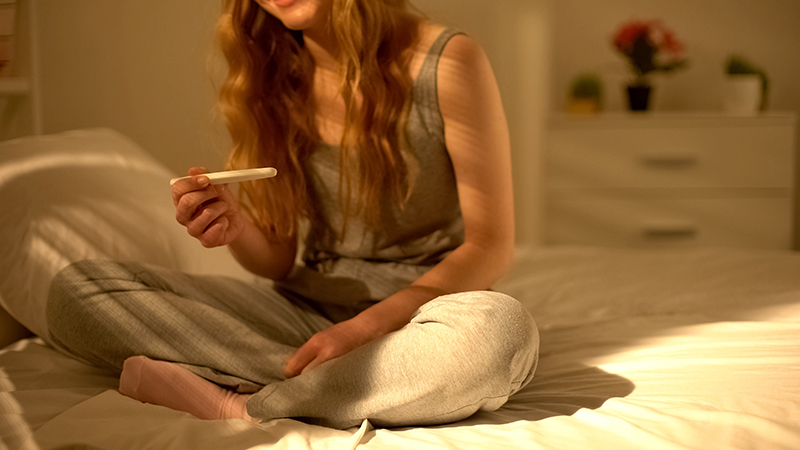 Woman reading pregnancy test.