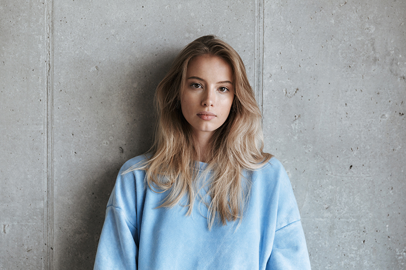 African-American woman looking off to side in contemplation.